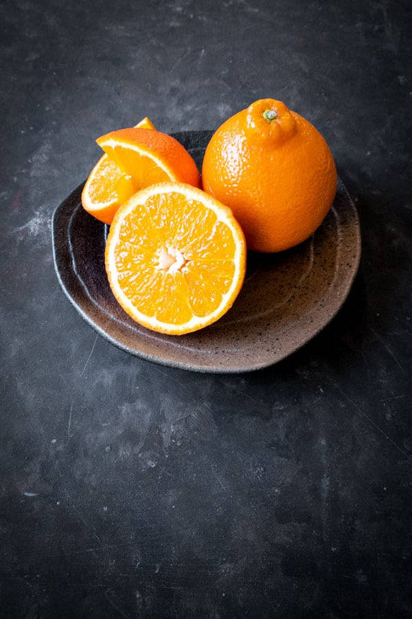 Fresh Tangelo Fruits In A Saucer Wallpaper