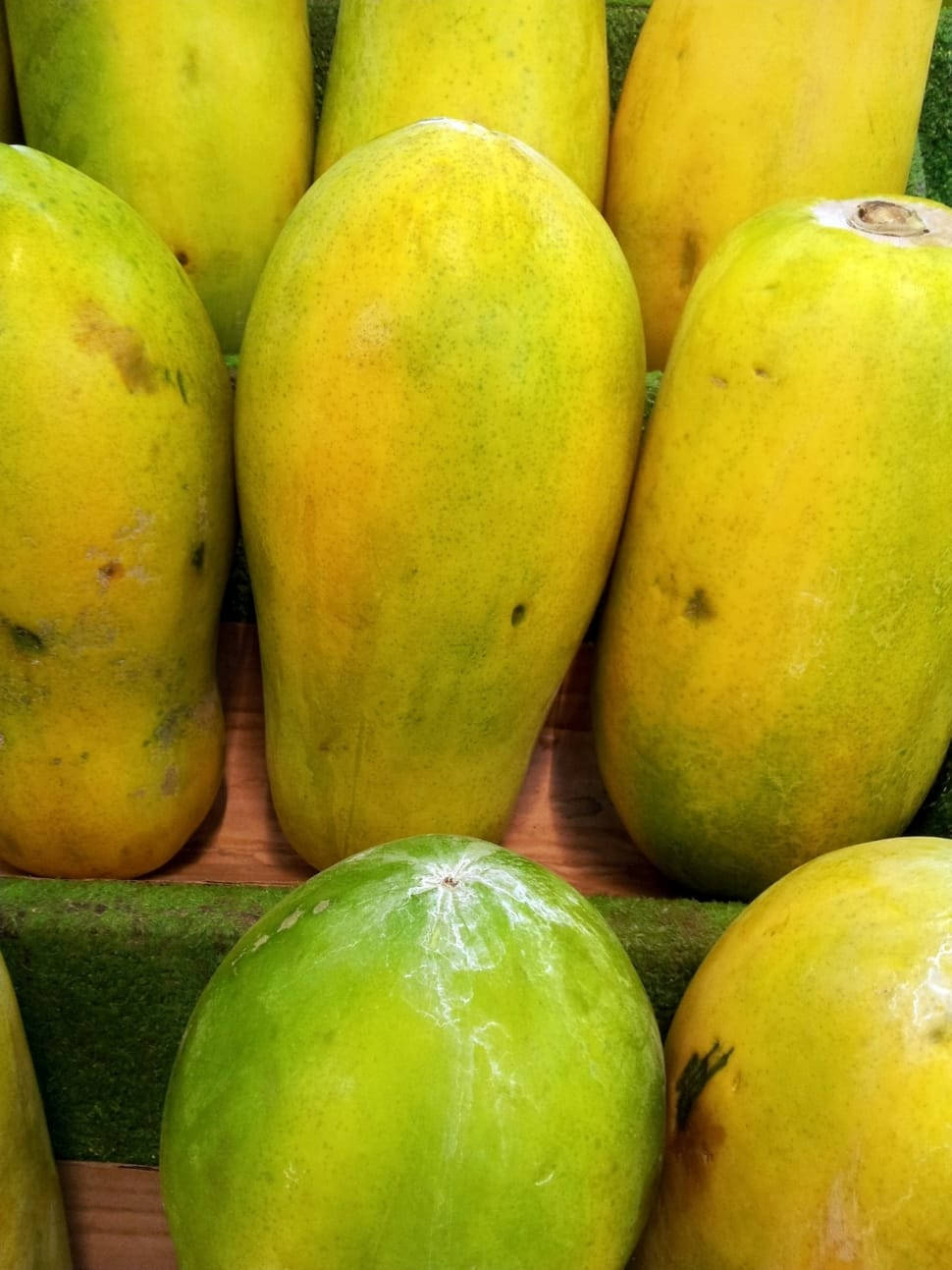 Fresh Vibrant Papayas Displayed On A Market Shelf. Wallpaper