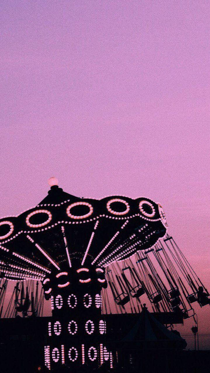 Gambar Swing Ride Under Pink Sky Wallpaper