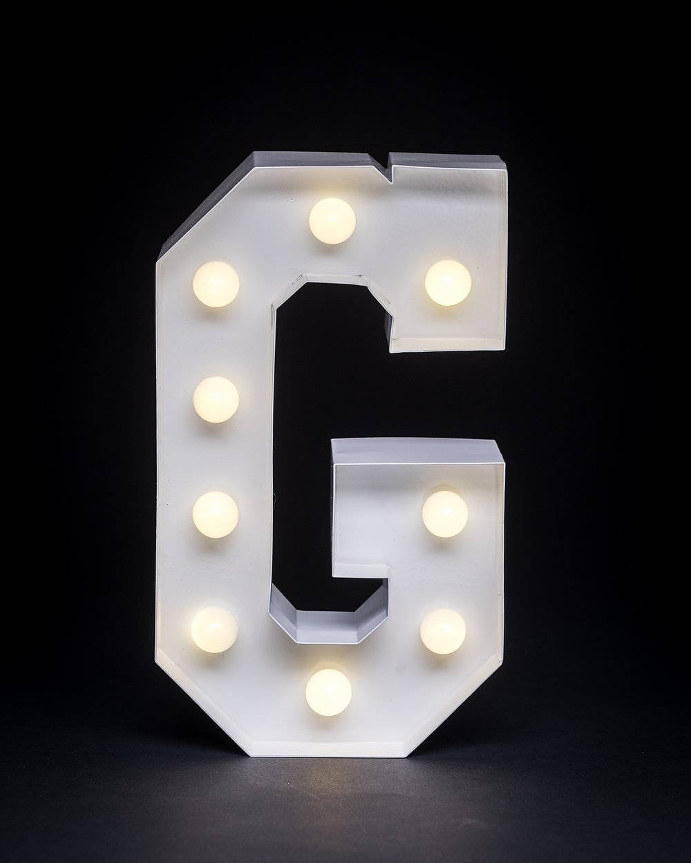 Glowing Letter G With Warm White Lights Wallpaper