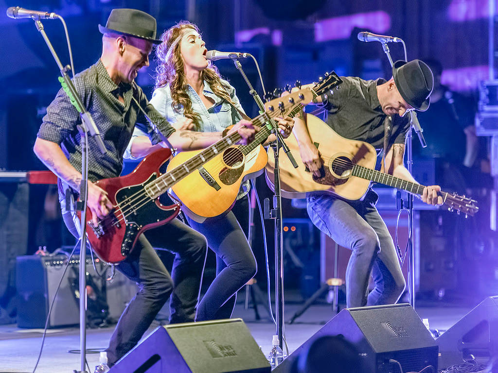 Grammy Winner Brandi Carlile Performing Live With Her Bandmates Wallpaper