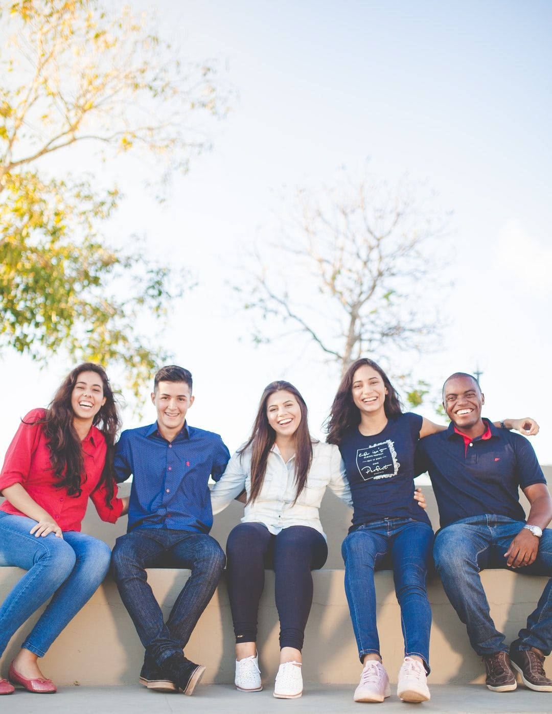 Group Of Friends Seated Together Wallpaper