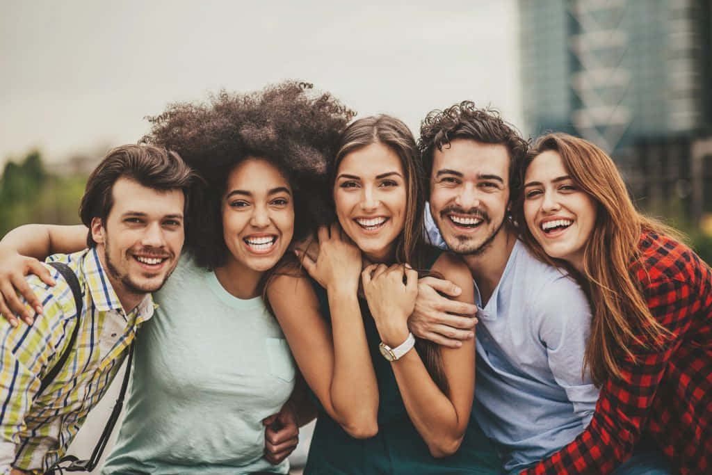 Group Of Young People Embracing Wallpaper