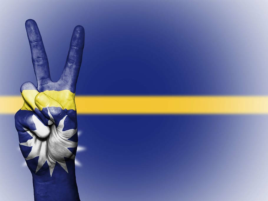 Hand Against Nauru Flag Wallpaper