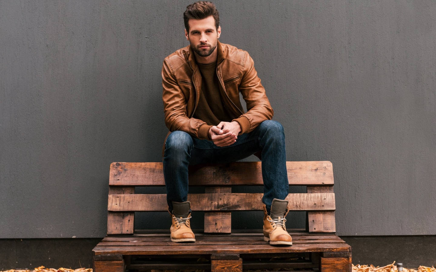 Handsome Man Sitting On Bench Wallpaper