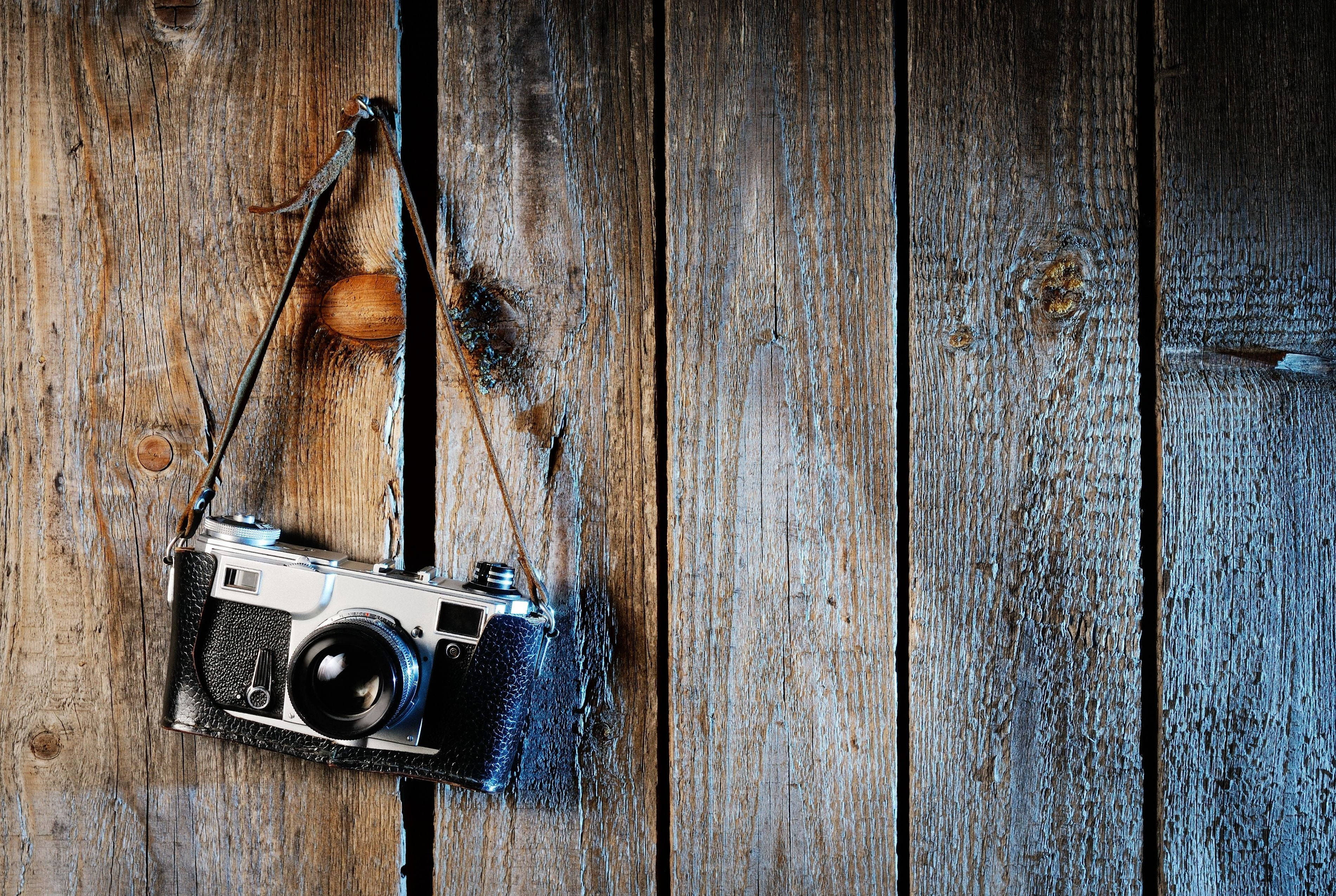 Hd Camera On Wooden Plank Wall Wallpaper