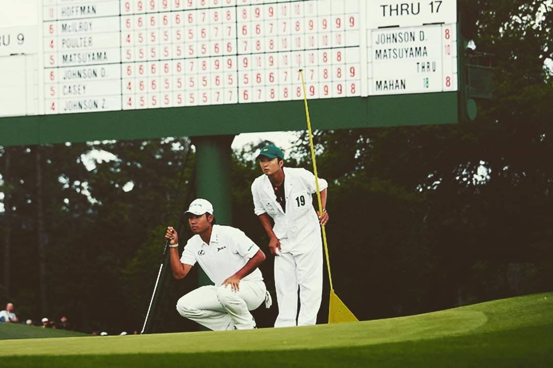 Hideki Matsuyama And Caddie Looking At Hole Wallpaper