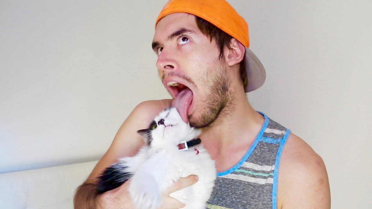 Holasoygerman Posing Playfully With His Cat Wallpaper