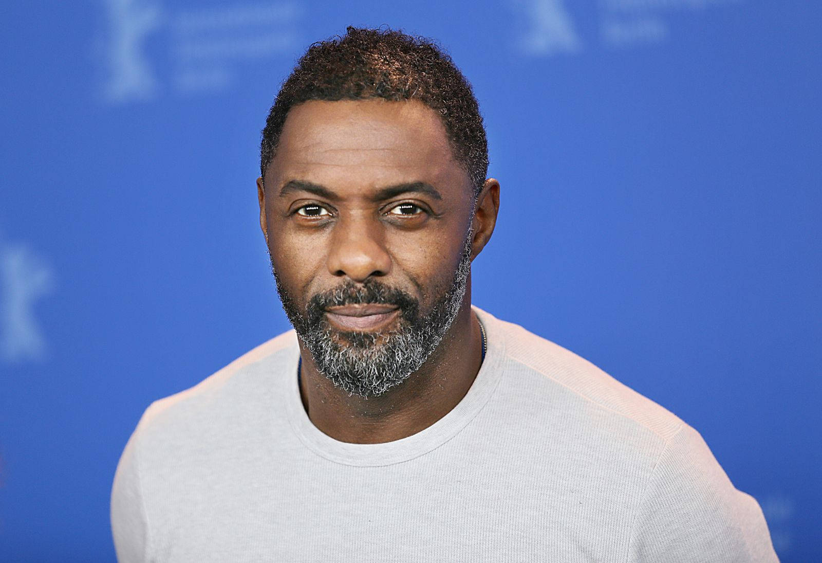 Idris Elba Against Blue Backdrop Wallpaper