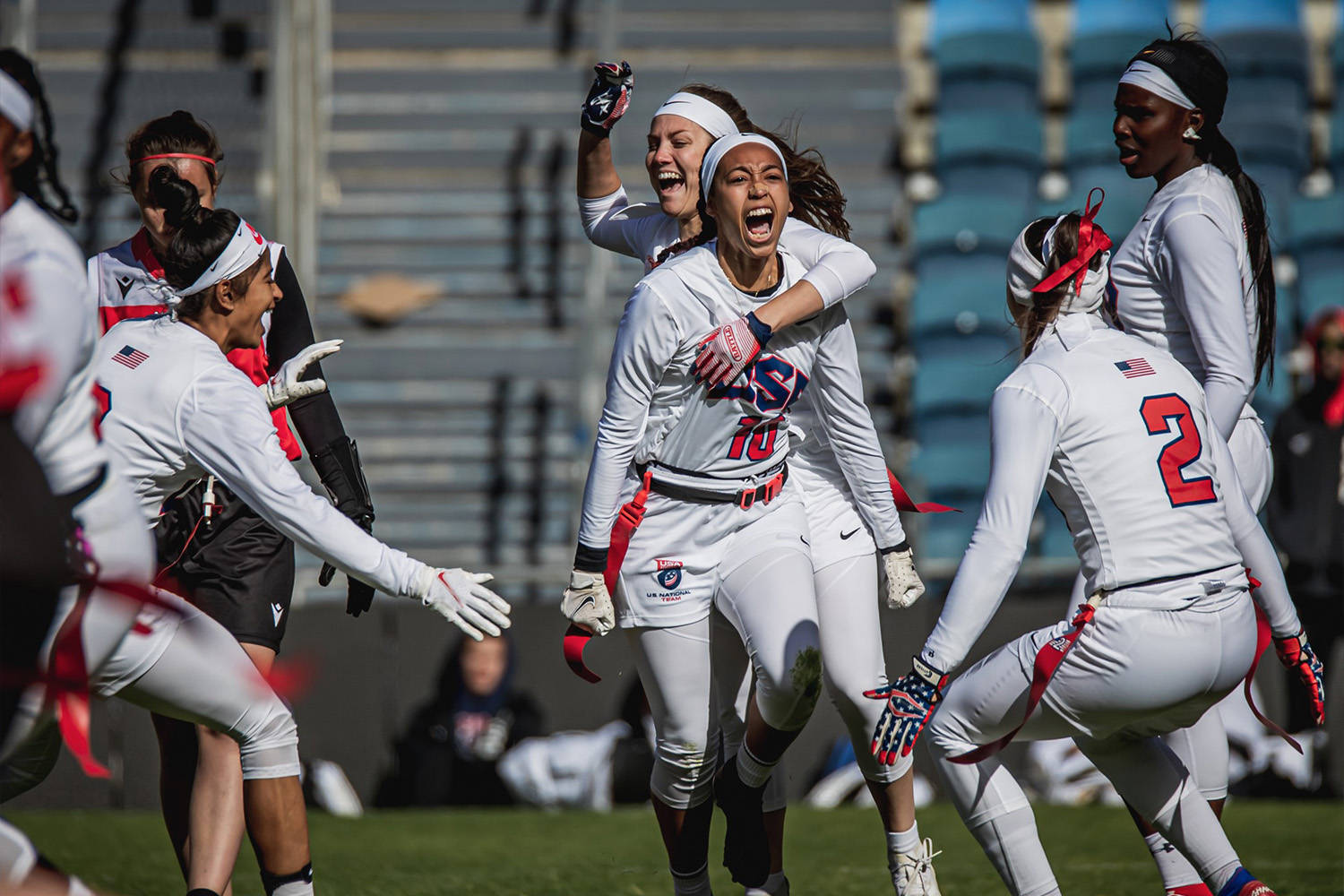 Intense Focus: Female Flag Football Athlete From Team Usa In Action Wallpaper