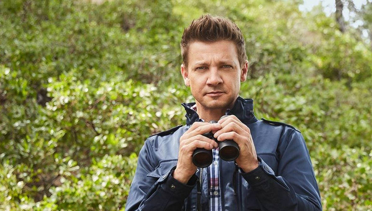 Jeremy Renner Analyzing Landscape With Binoculars Wallpaper