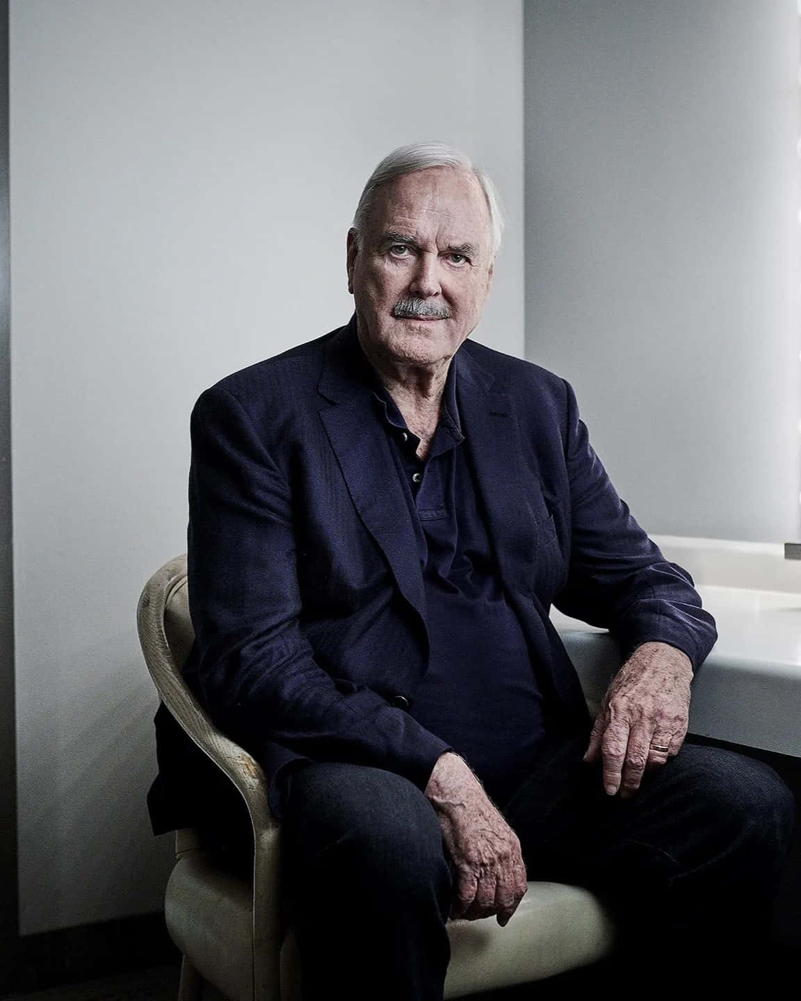 John Cleese Portrait Sitting Wallpaper