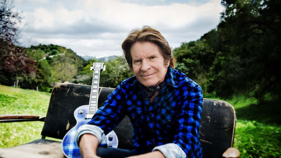 John Fogerty Outdoor Portraitwith Guitar Wallpaper