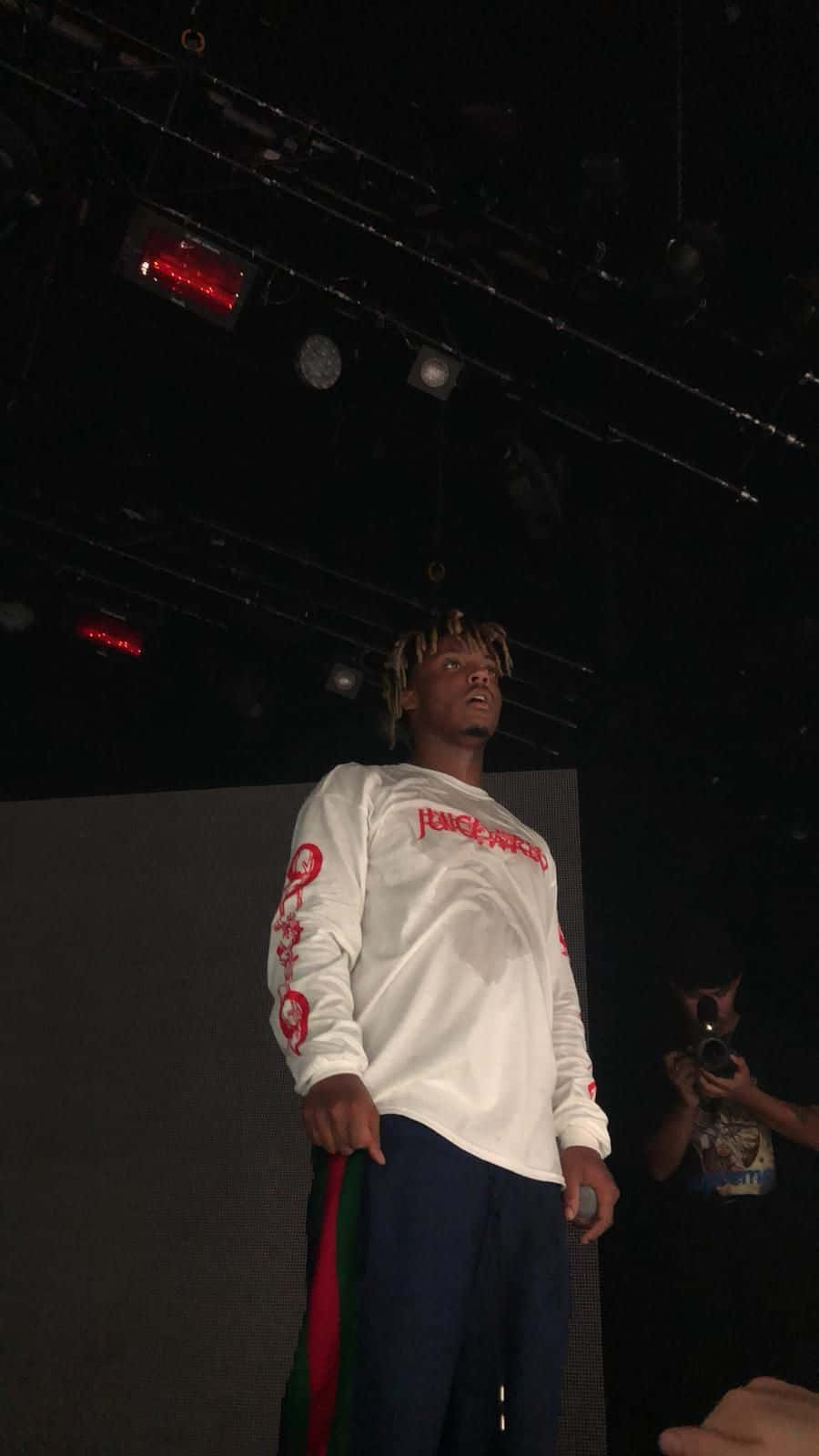 Juice Wrld Surrounded By His Iconic Music Wallpaper