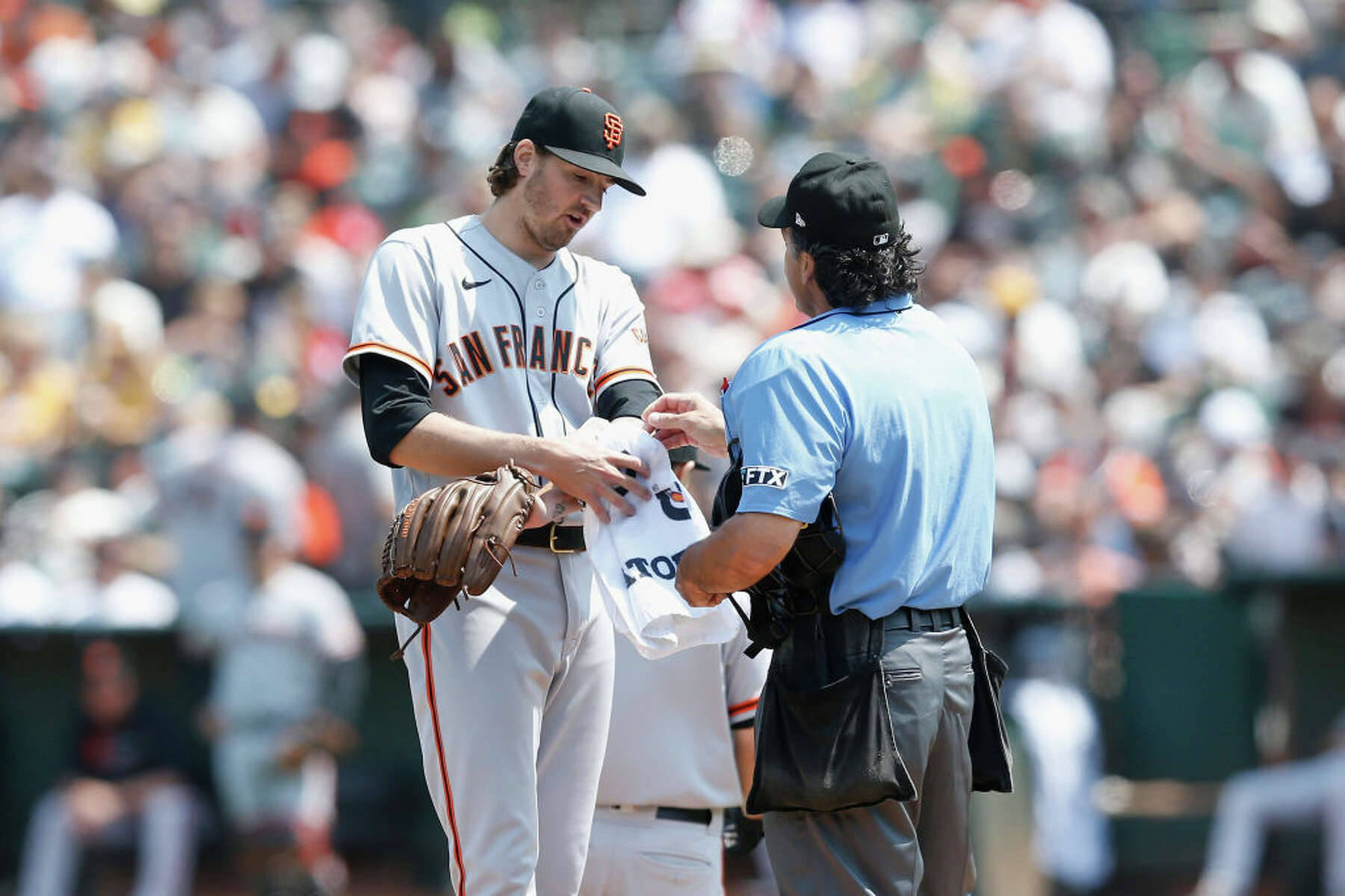 Kevin Gausman Covering White Towel On His Left Arm Wallpaper