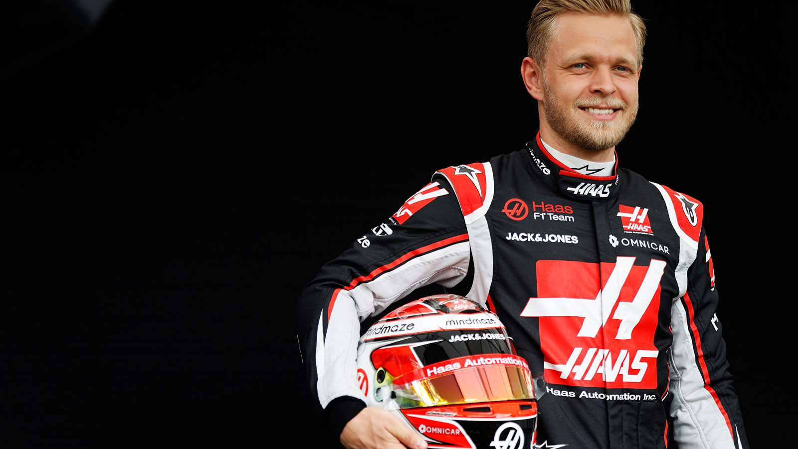 Kevin Magnussen Holding His Helmet In Confidence Wallpaper