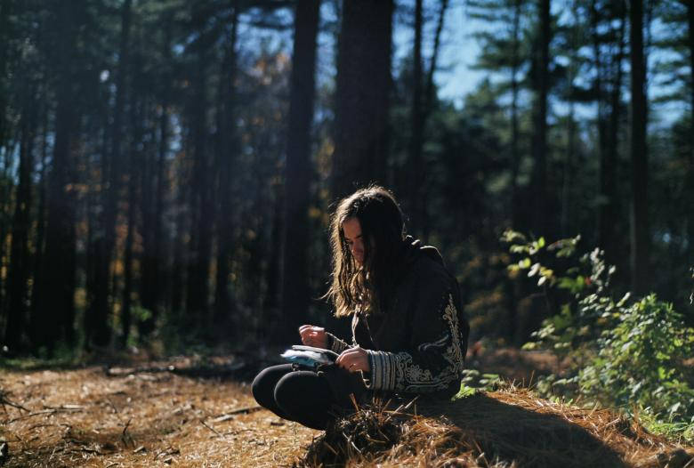 Lonely Woman Writing In The Woods Wallpaper