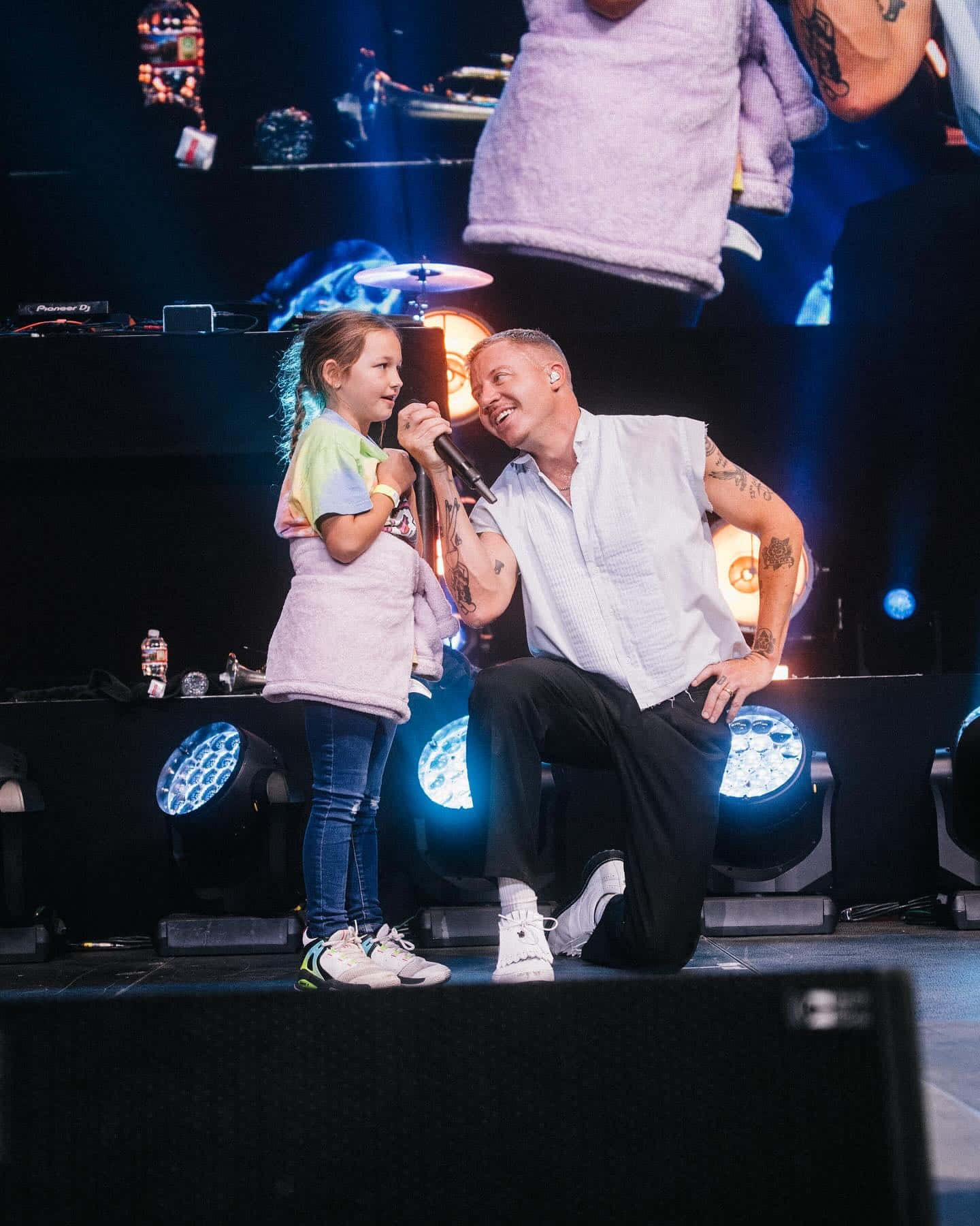 Macklemore Performingwith Young Fan Wallpaper