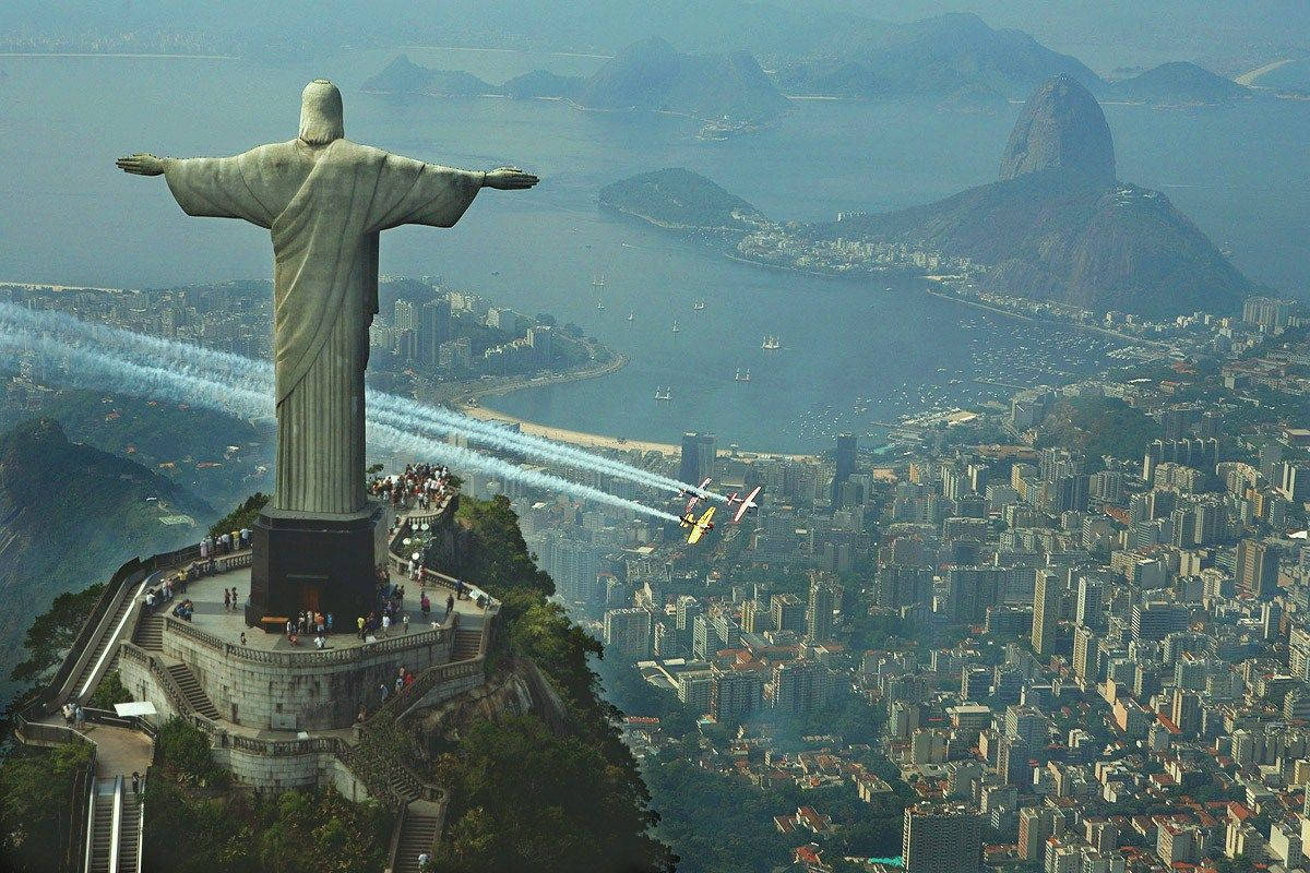 Majestic Christ The Redeemer Statue In Rio De Janeiro Wallpaper