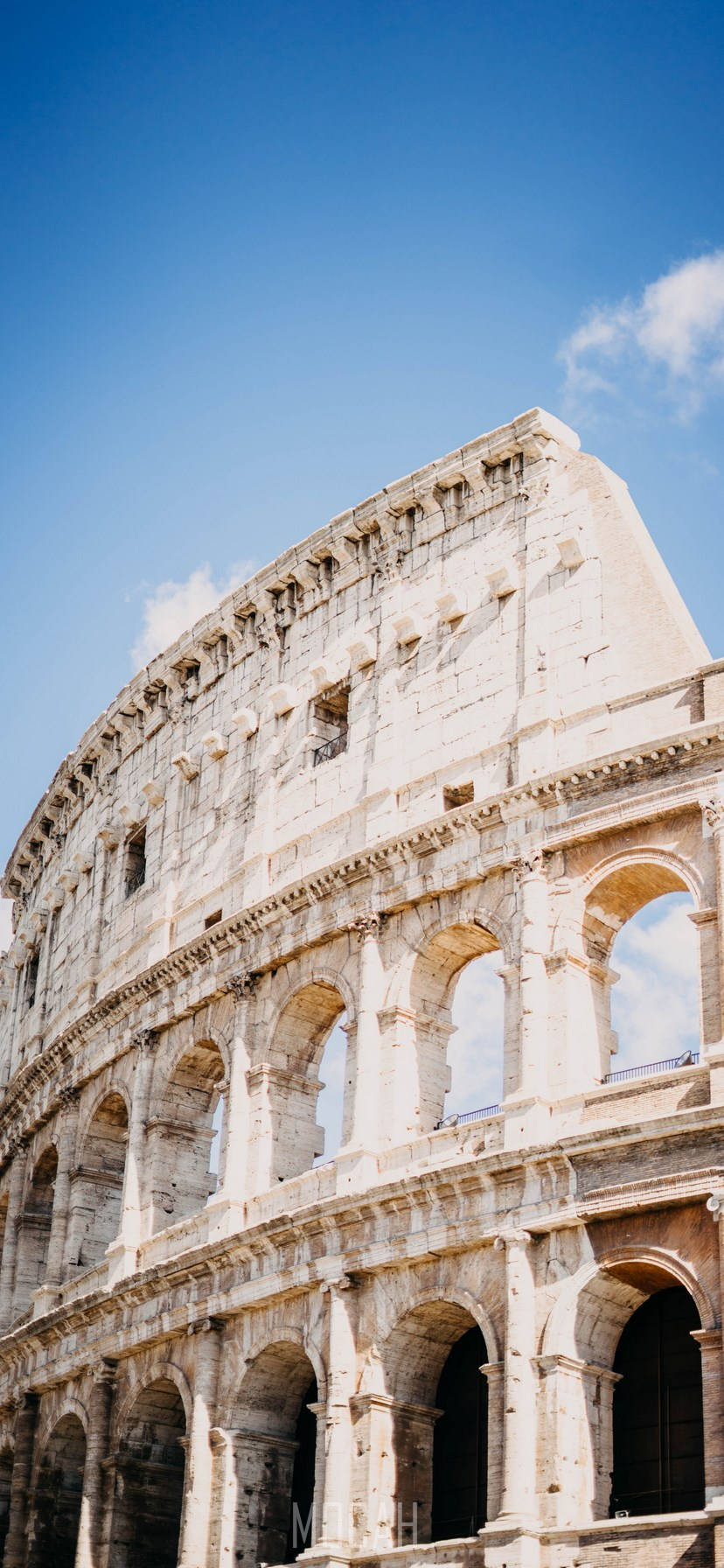 Majestic Colosseum Under Clear Blue Sky Wallpaper