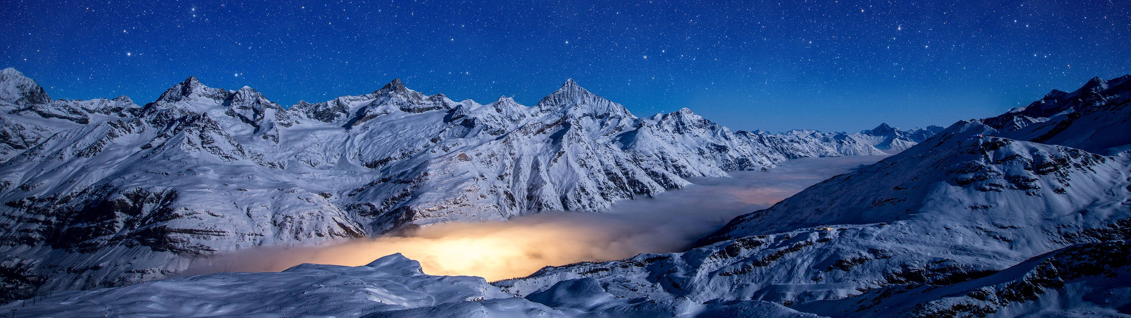 Majestic Snowy Mountain With Vibrant Blue Skies Wallpaper