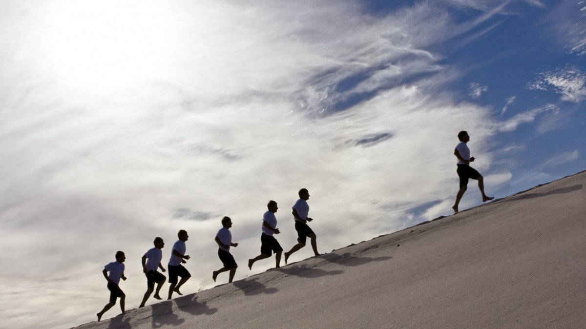 Man Lead Others Up A Hill Wallpaper