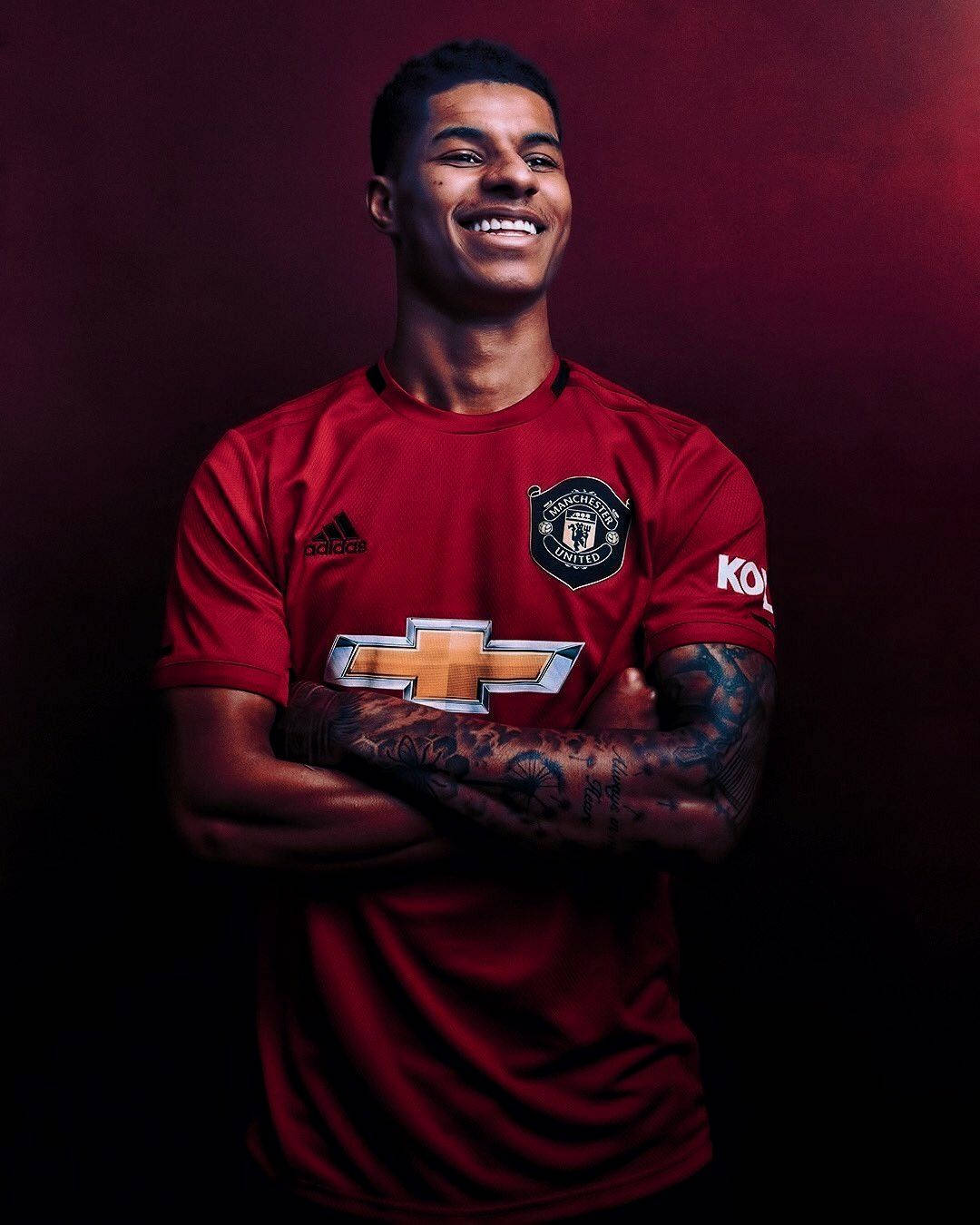 Marcus Rashford Crossed Arms Smiling Wallpaper