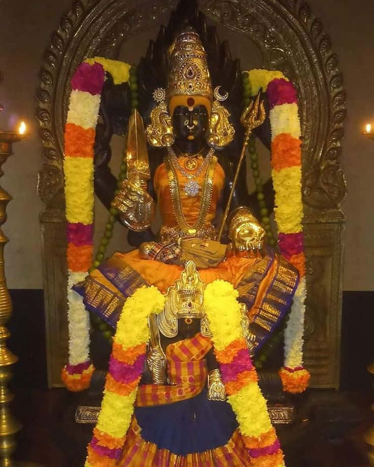 Mariamman Hindu Goddess Statue Adorned With Flowers Wallpaper