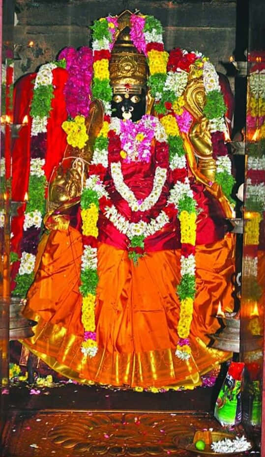 Mariamman Hindu Goddess Statue Adorned With Flowers Wallpaper