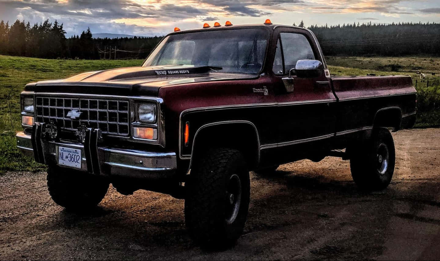 Maroon Jacked Up Trucks Wallpaper