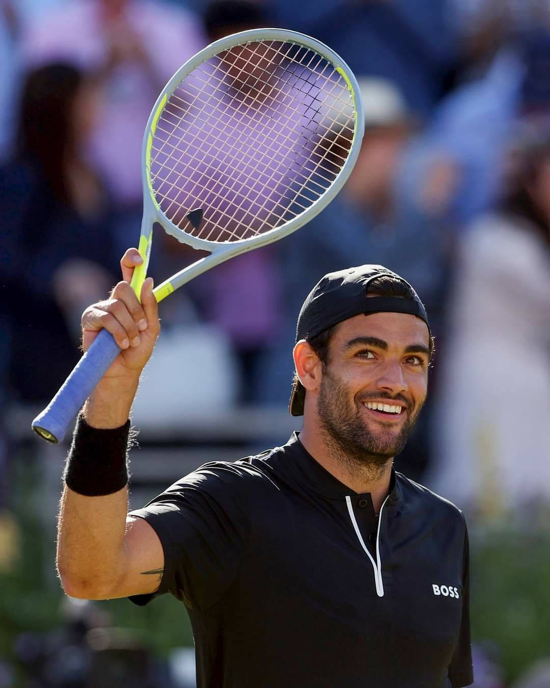 Matteo Berrettini Celebrating Victory With Racket Held High Wallpaper