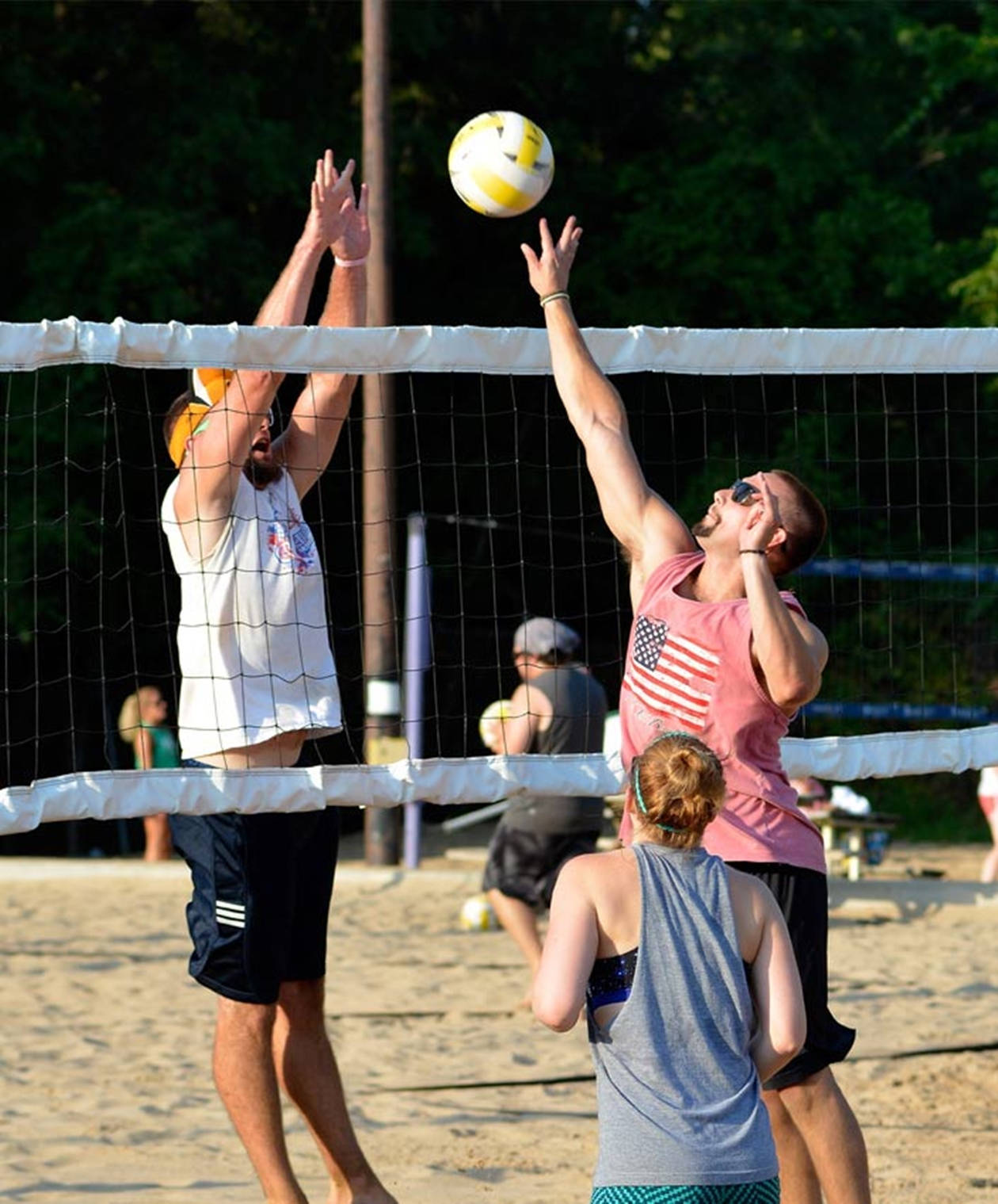 Men And Woman Playing Beach Volleyball Wallpaper