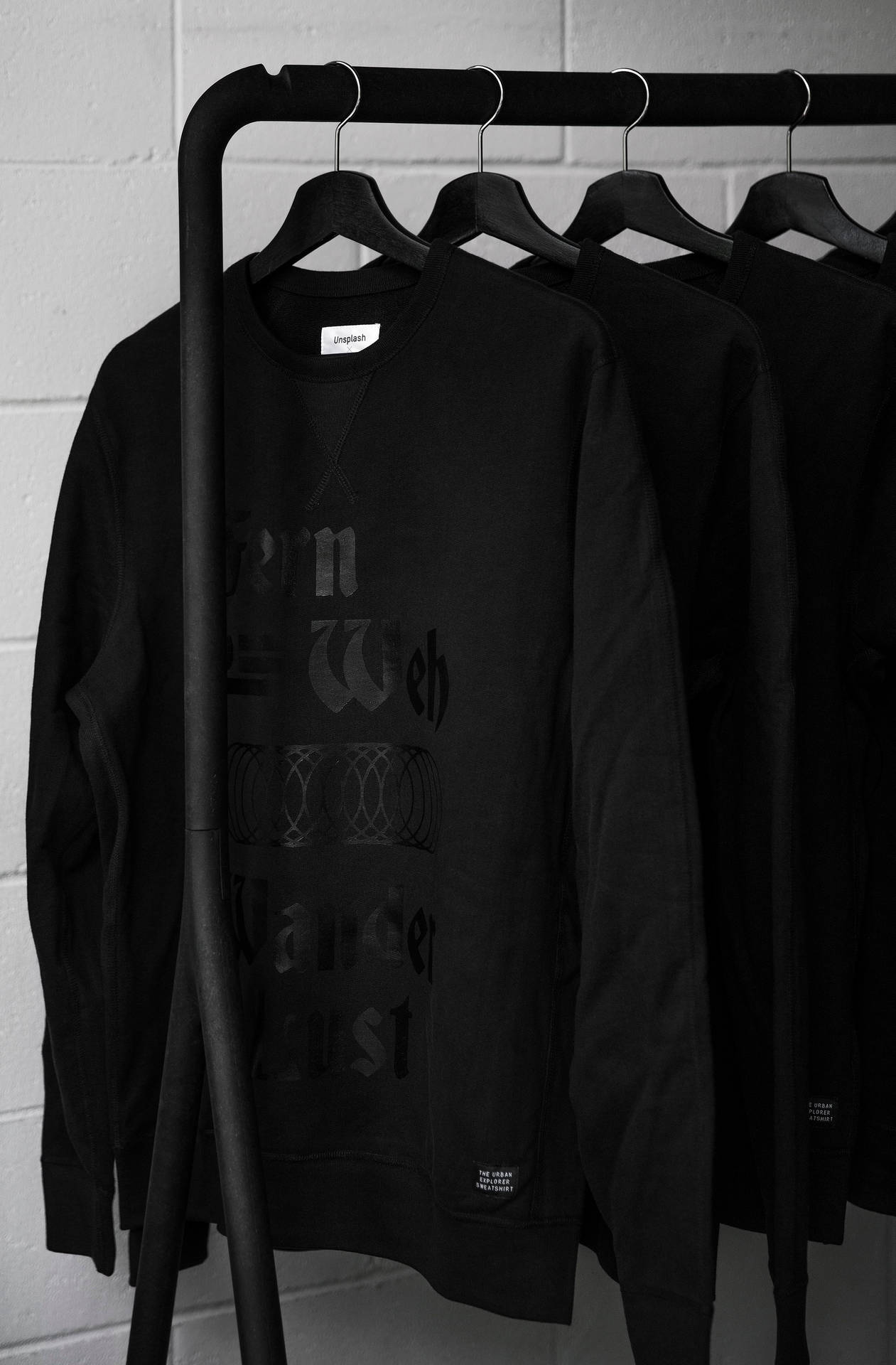 Minimalist Clothes Rack With Sweatshirts Wallpaper