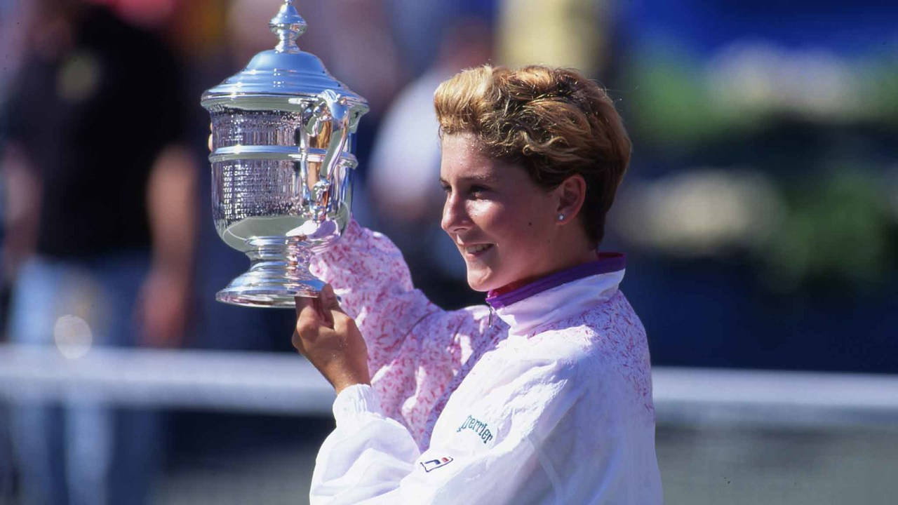 Monica Seles Triumphantly Holding Her Trophy Wallpaper