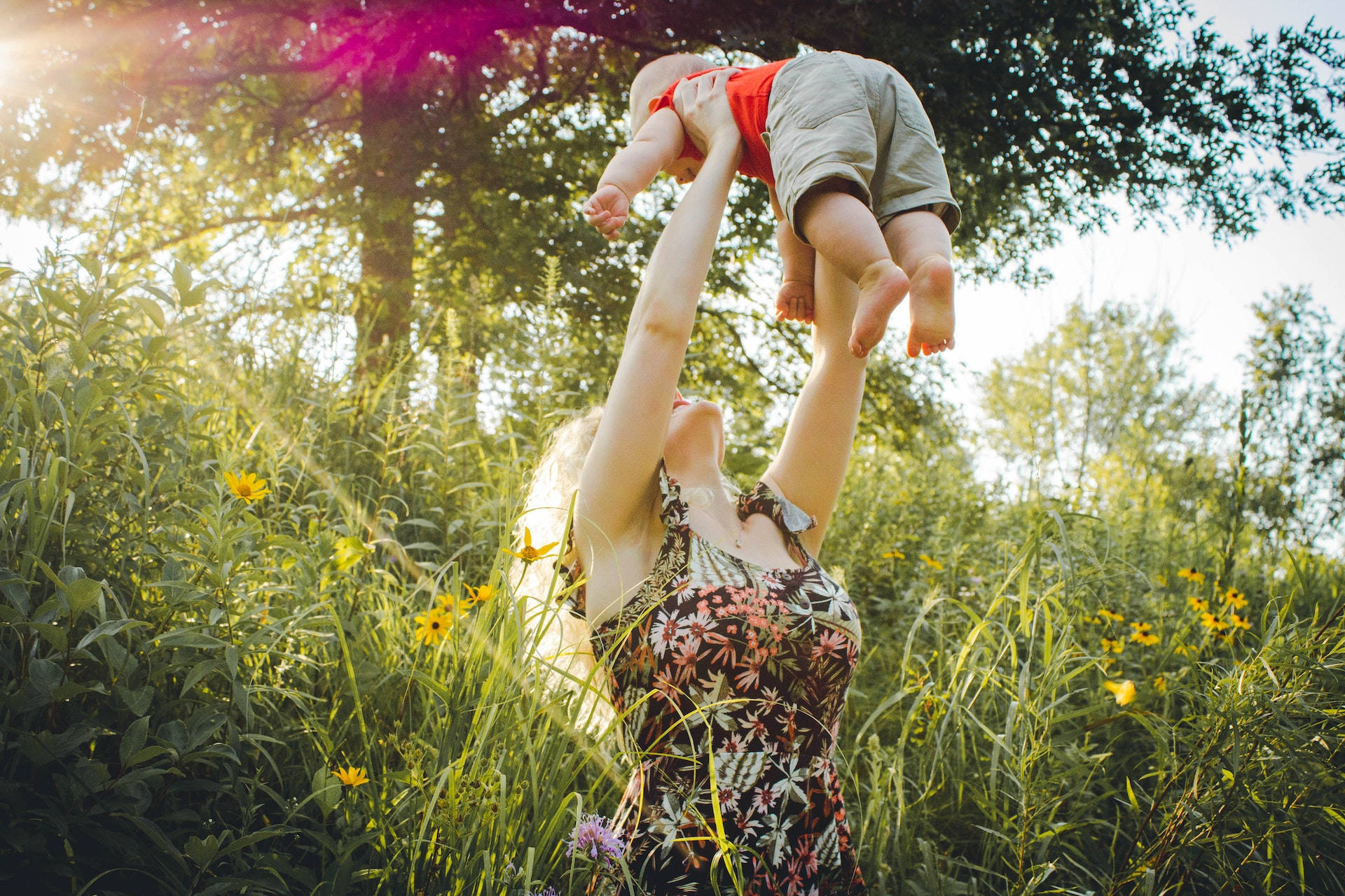 Mother Lifting Baby Love Wallpaper