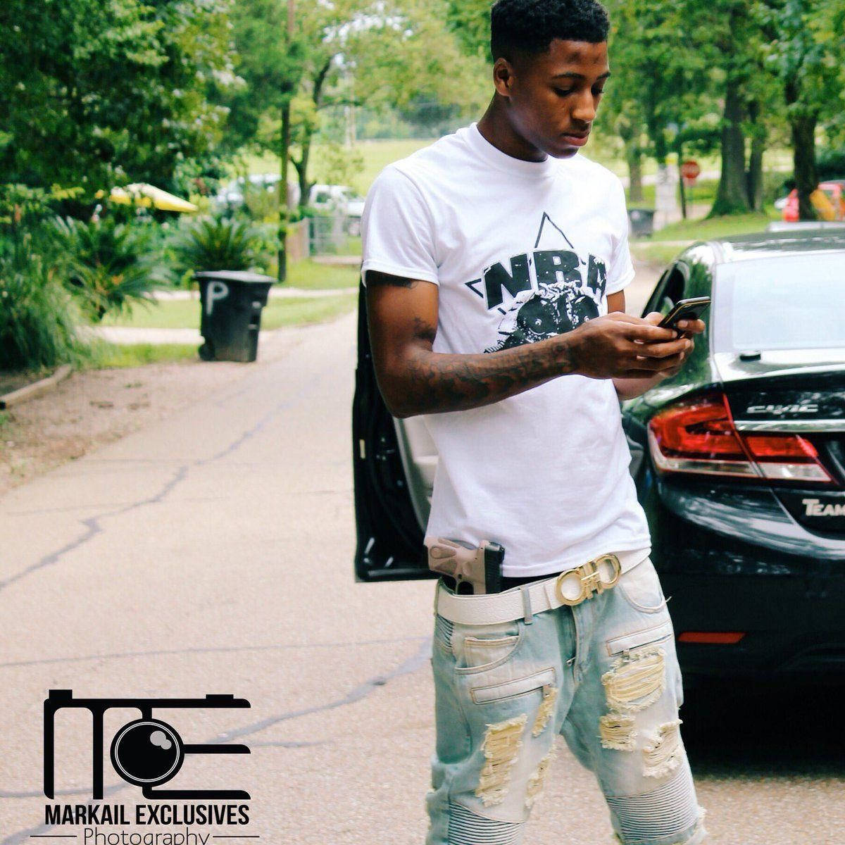 Nba Youngboy Demonstrates His Street Style As He Texts On The Move. Wallpaper