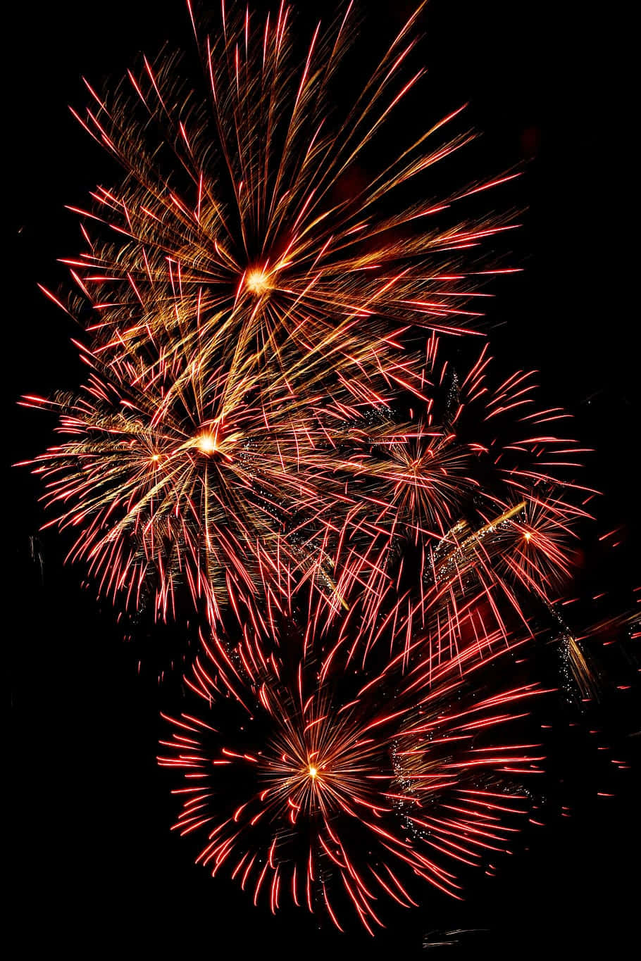 Orange Fireworks Display In Dark Sky Wallpaper