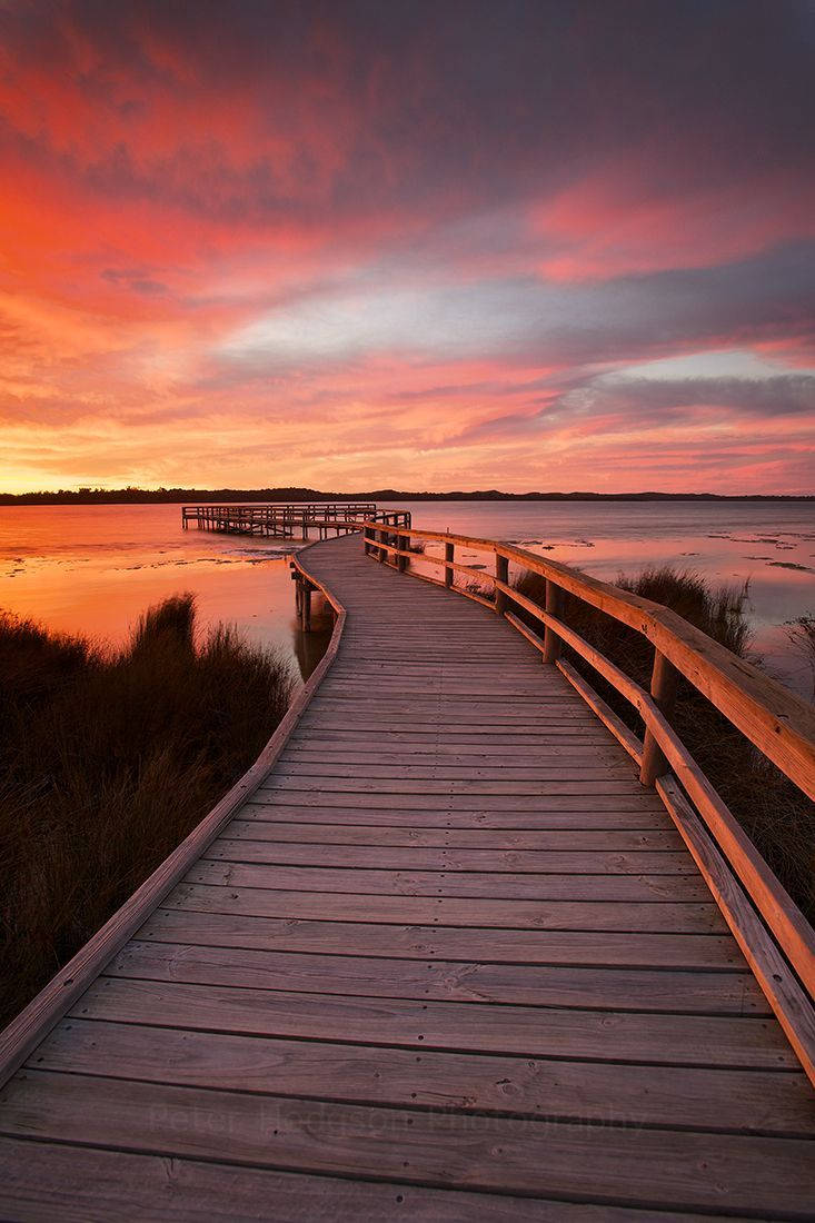 Orange Sunset Over Lake Dock Portrait Wallpaper