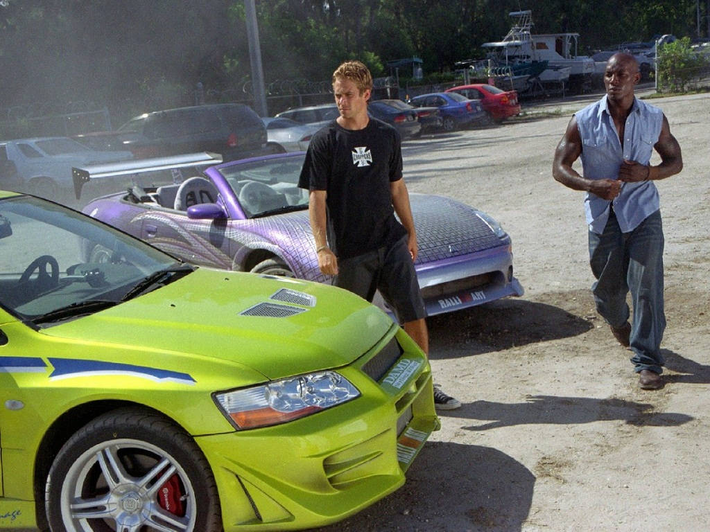 Paul Walker Behind The Wheel Of His Favorite Race Car Wallpaper