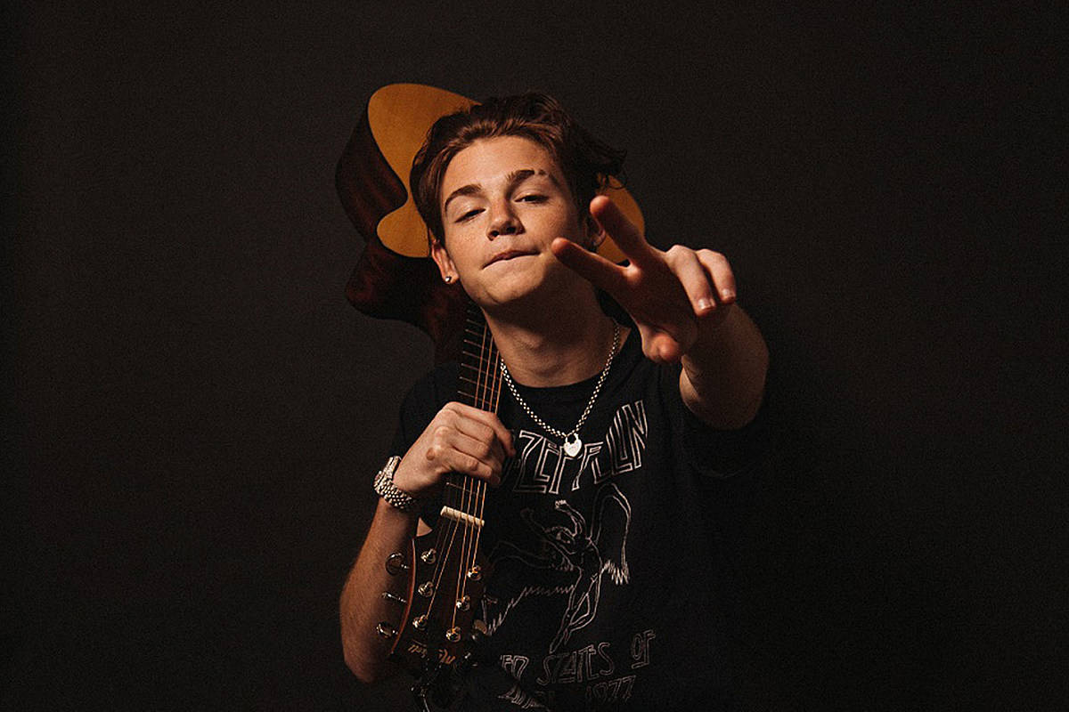 Payton Moormeier Holding A Guitar Wallpaper