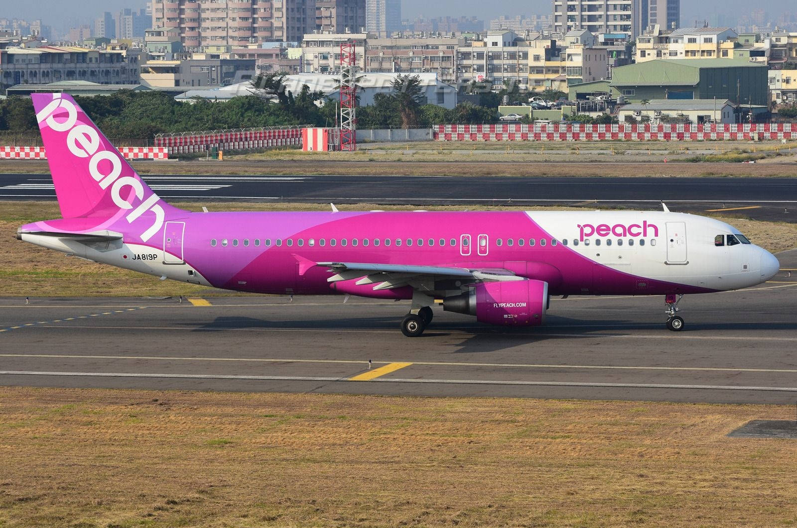 Peach Aviation Airplane On Runway Wallpaper