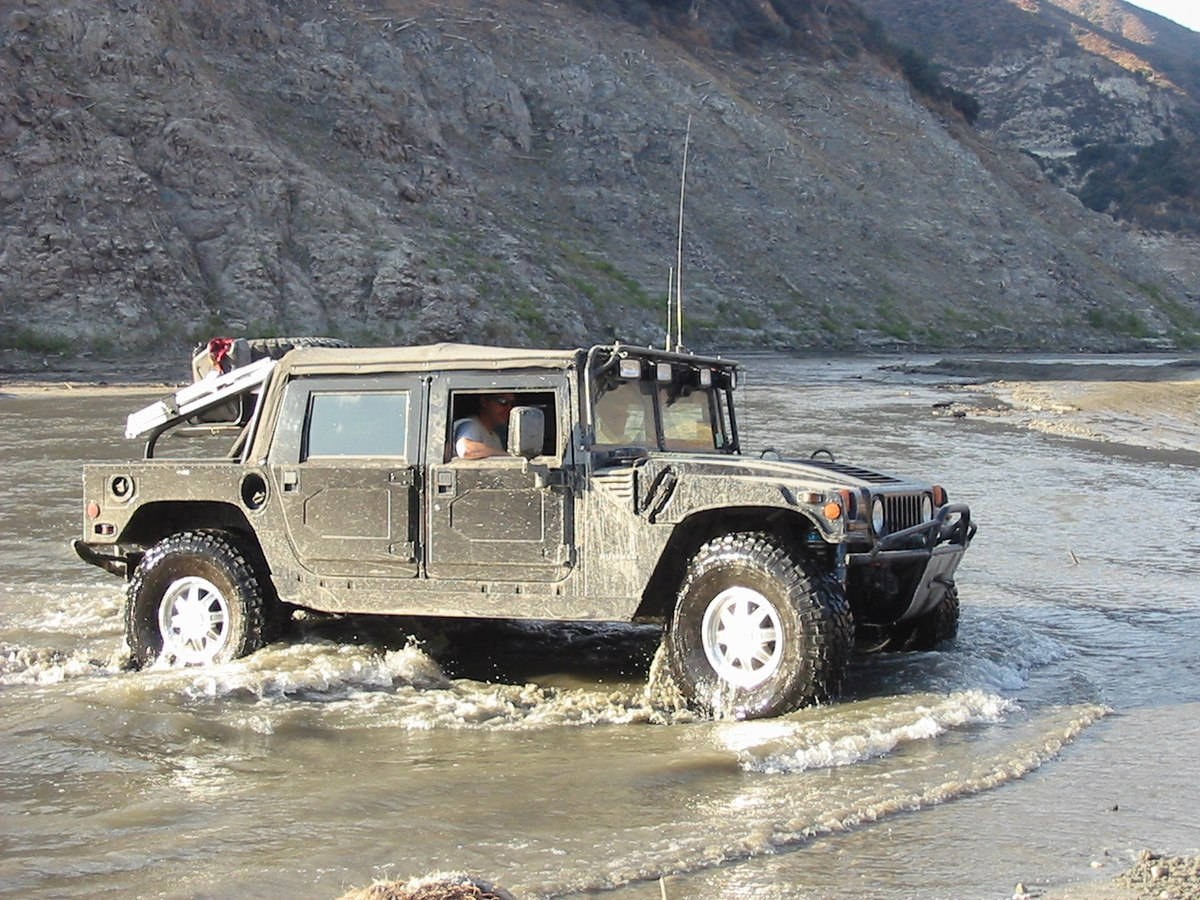 Powerful Hummer Making Its Way Through A River Wallpaper