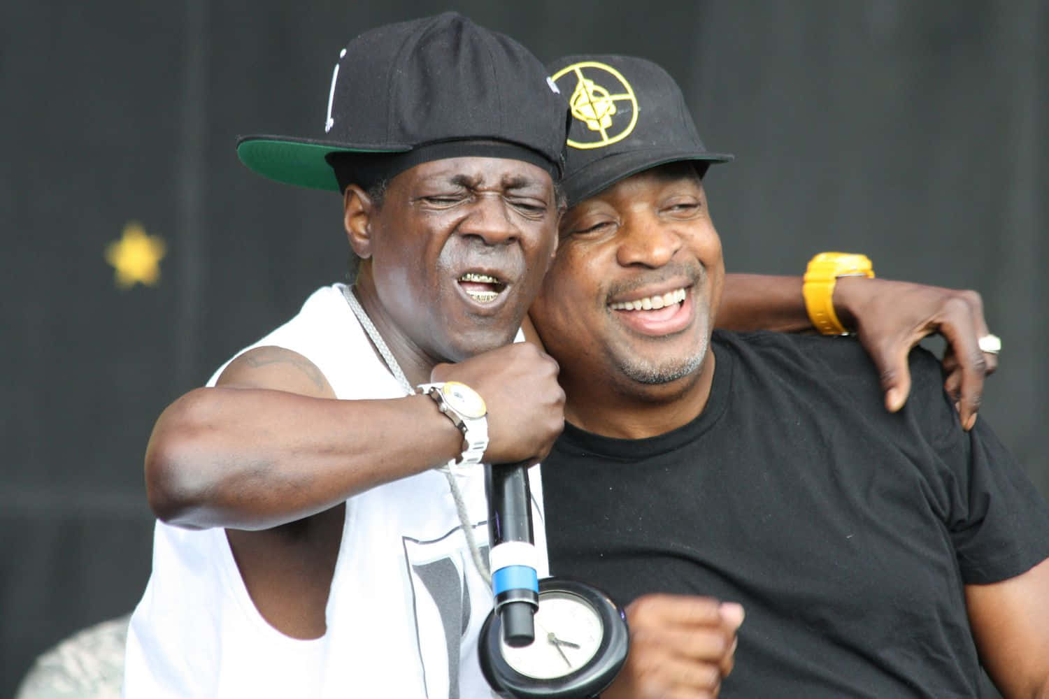 Public Enemy Members Embraceon Stage Wallpaper