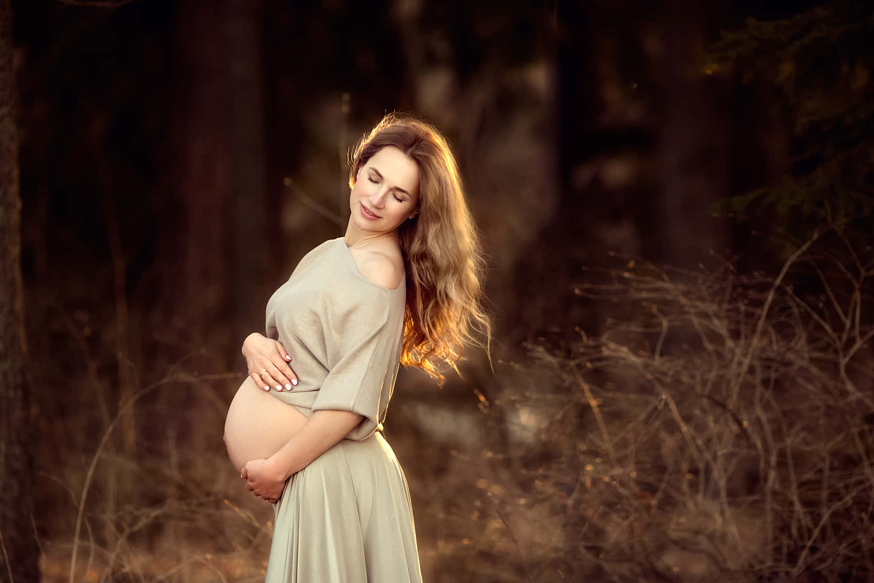 Radiant Expecting Mother With Baby Bump Wallpaper