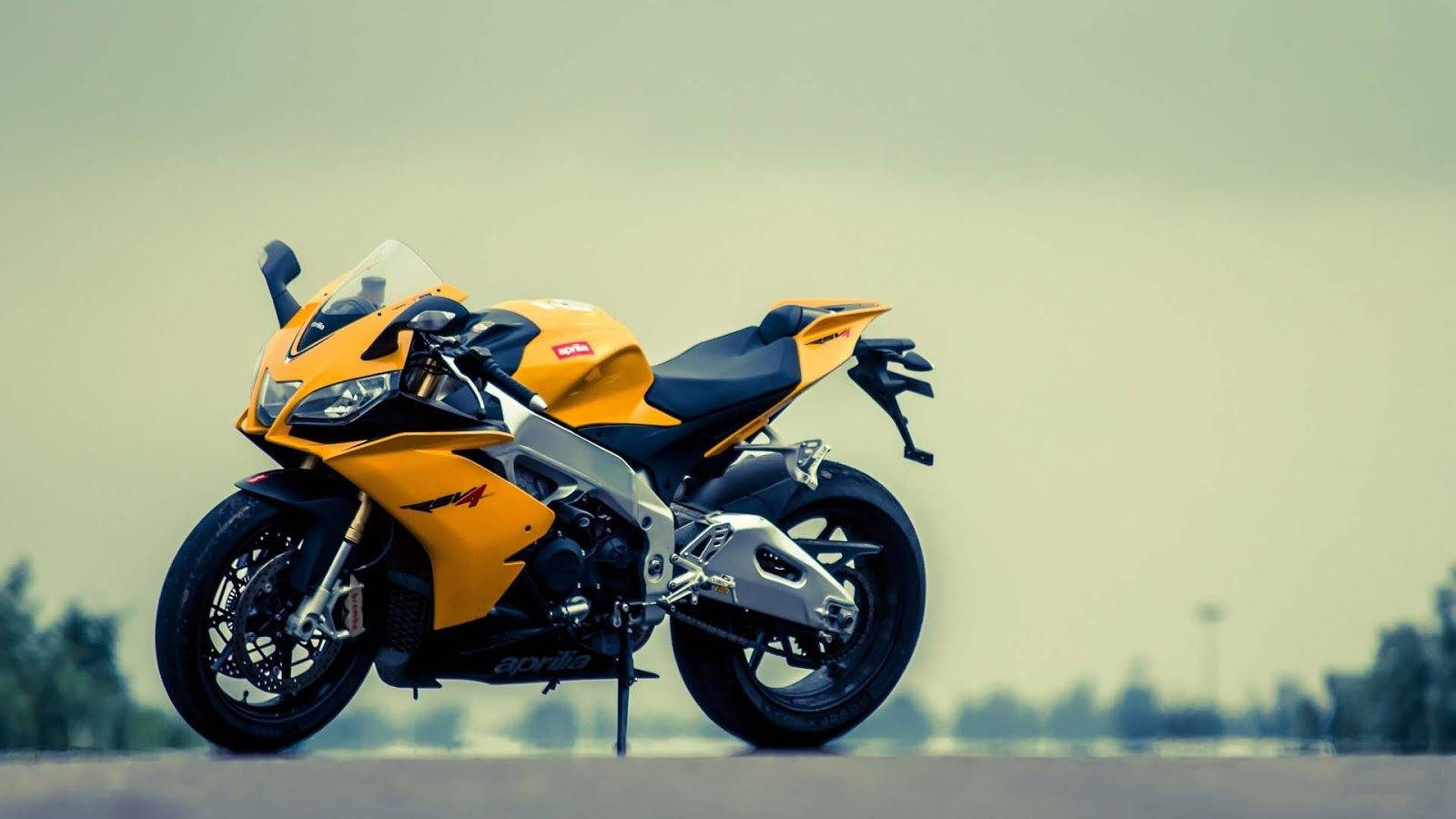 Ready To Ride The Yellow Aprilia Rsv4 Motor Bike Wallpaper