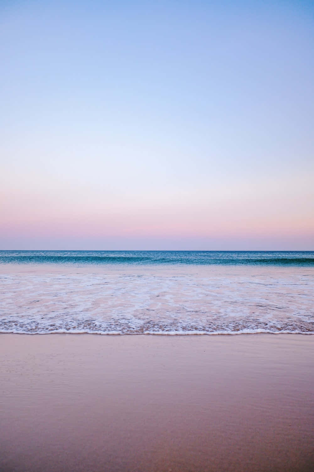 Relax On The Tranquil Pastel Coloured Beach, Perfect For Summer Days. Wallpaper