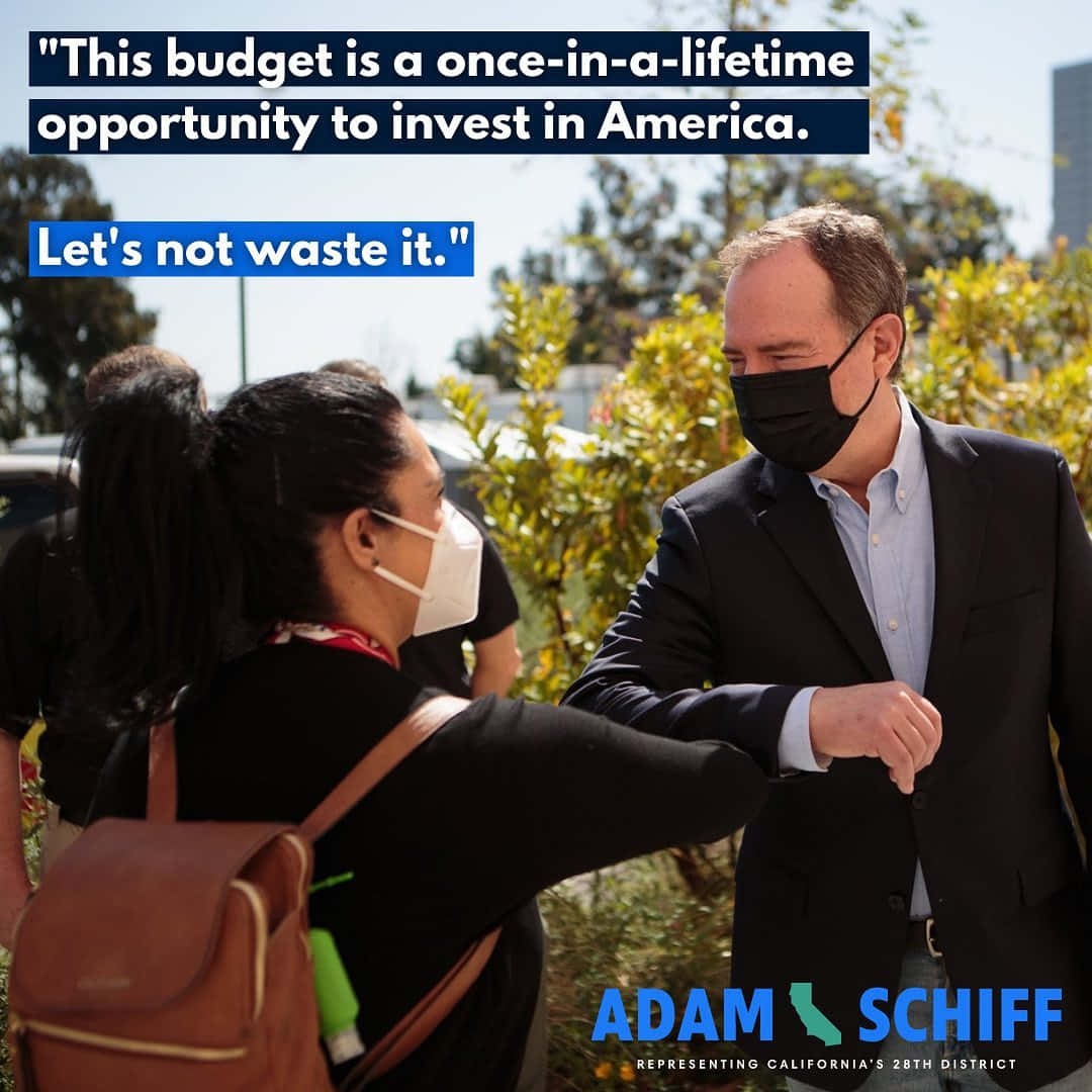 Representative Adam Schiff Engaging In A Playful Elbow Bump With A Young Girl Wallpaper