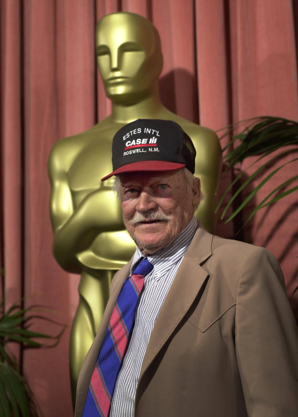 Richard Farnsworth Holding His Golden Trophy Statue Wallpaper