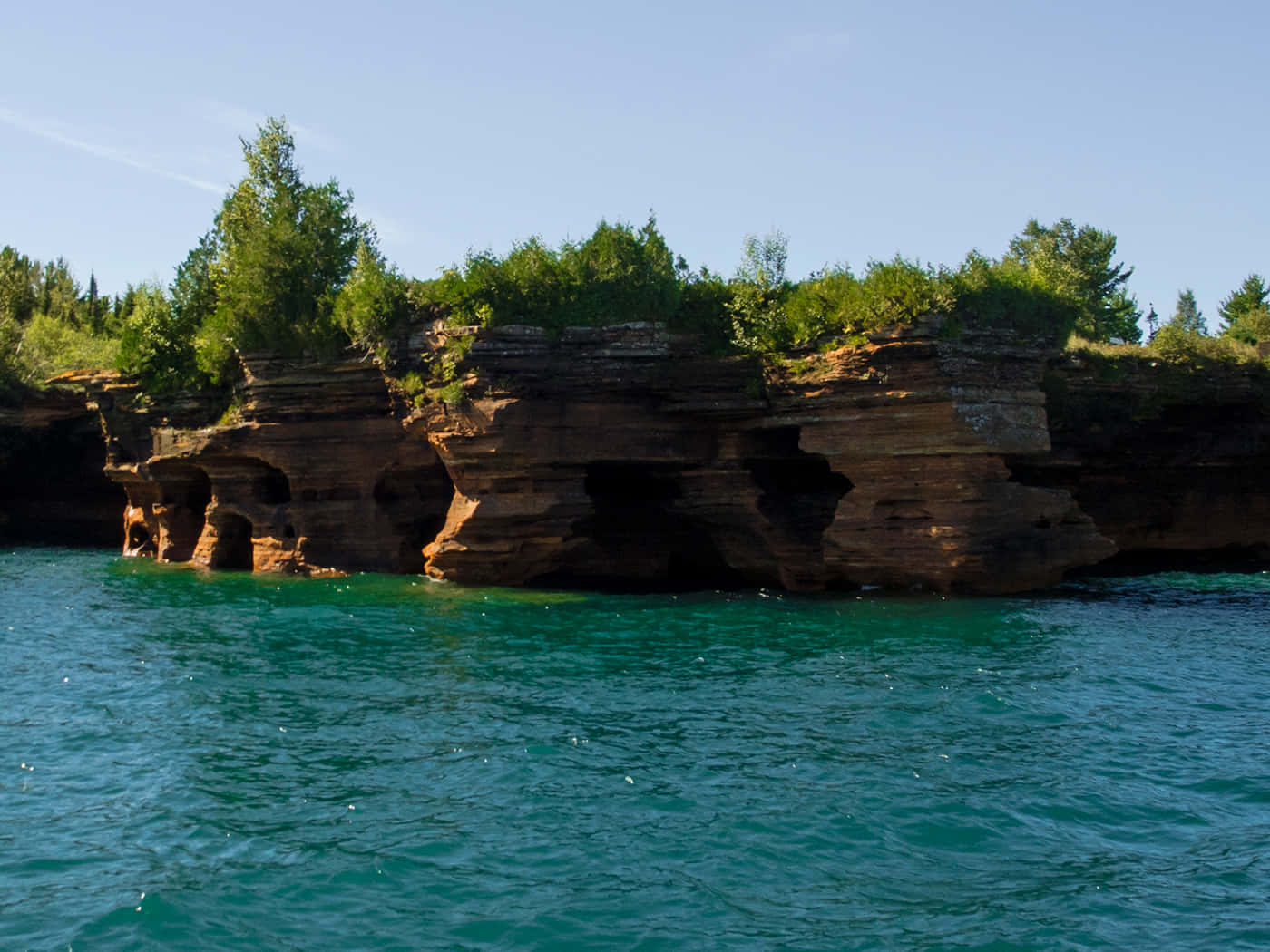 Rocky_ Cliffside_ Over_ Turquoise_ Water Wallpaper
