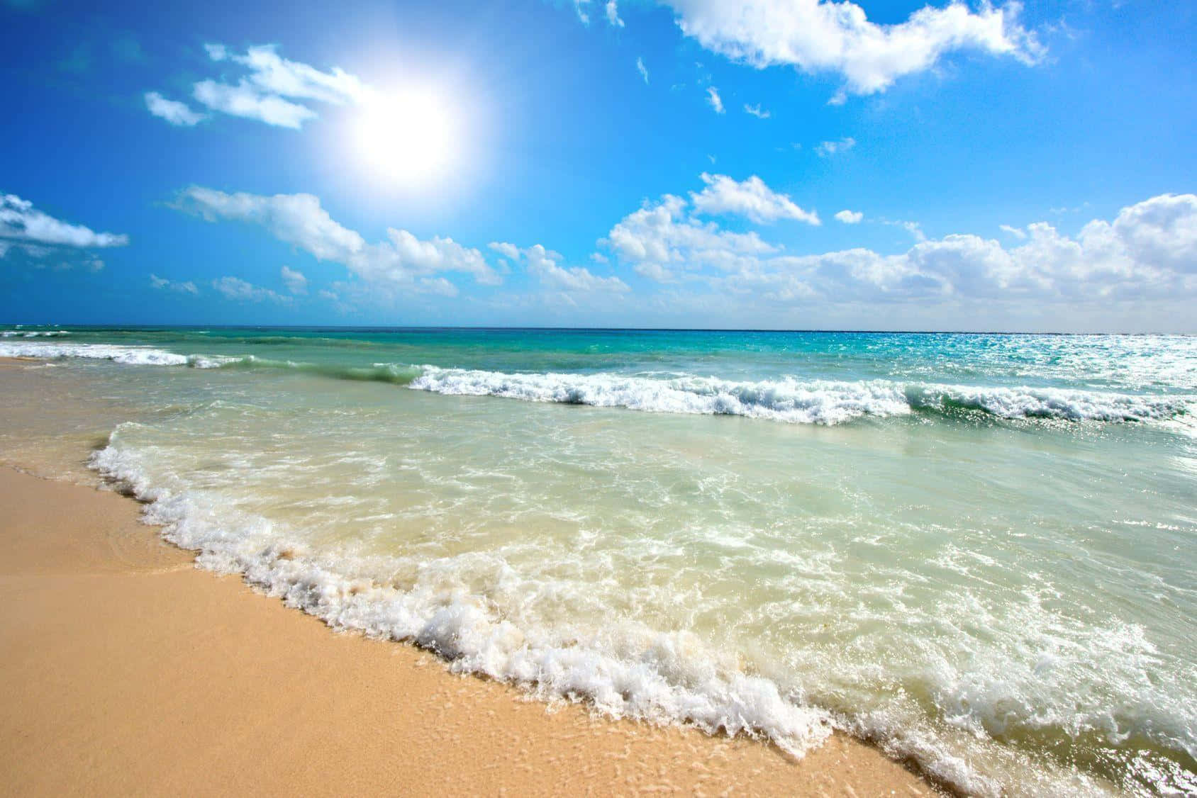 Sandy Beach Scene Waves Sunny Sky Wallpaper